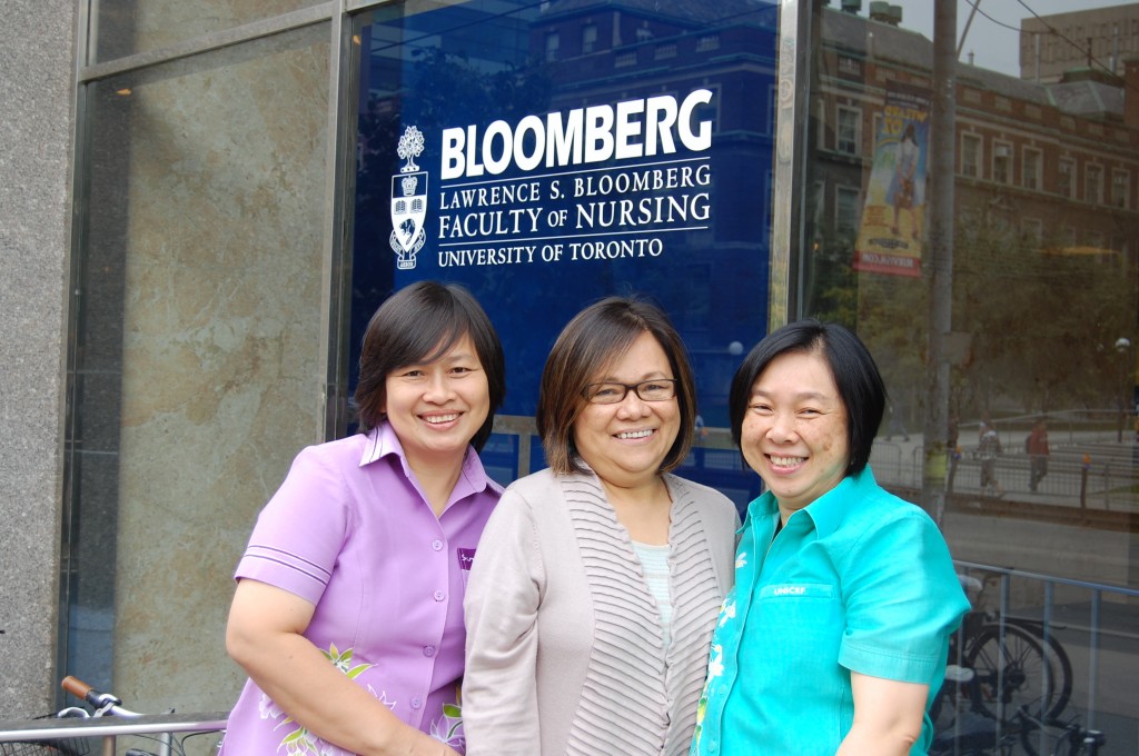 Thai visitors pose with Freida Chavez outside of Bloomberg Nursing