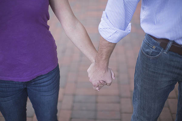 A man and woman holding hands.