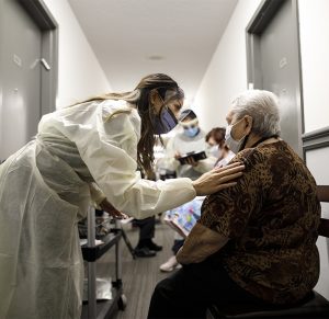 Nurse speaks to residents during vaccine clinic in Toronto