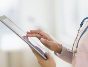 nurse using digital tablet in hospital