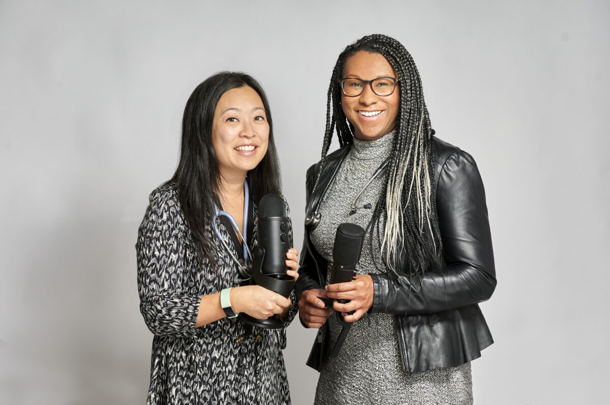 Sara Fung and Amie Archibald-Varley holding microphones featured against a grey background