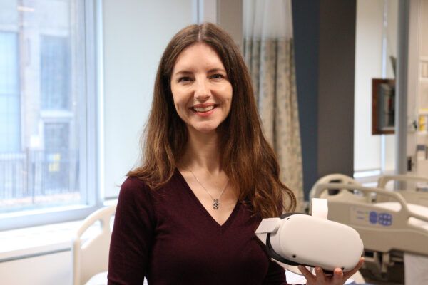 Heather Thomson in Sim Lab holding VR Headset